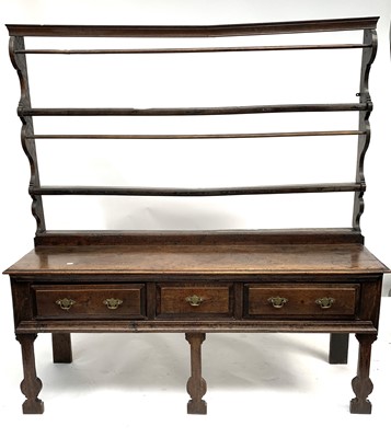 Lot 3093 - A Georgian oak open dresser and rack, fitted...