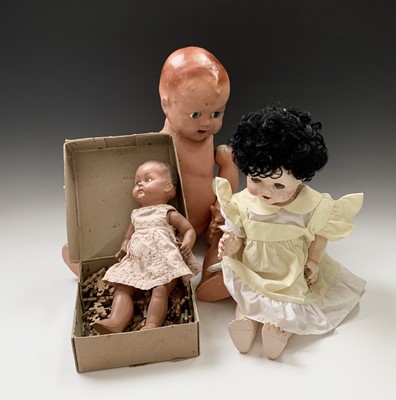 Lot 592 - Four dolls and two jigsaws in one box.