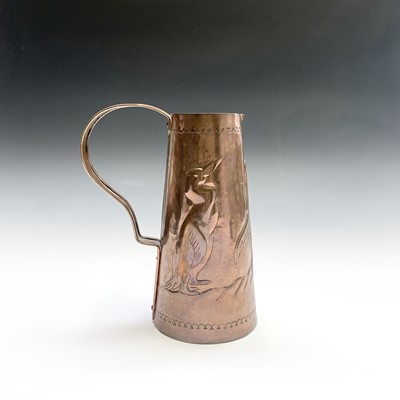 Lot 50 - A Newlyn copper jug, repousse decorated with...