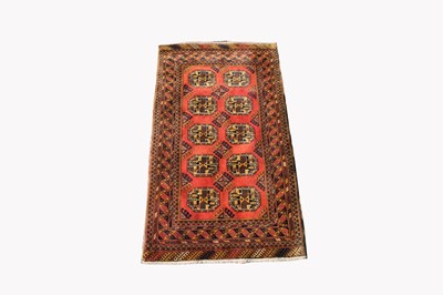 Lot 496 - An Afghan rug, the madder field with five rows...