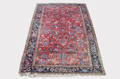 Lot 446 - A Heriz carpet, North West Persia, the madder...