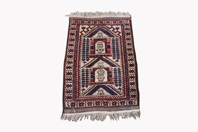 Lot 460 - A Belouch prayer rug, the polychrome mihrab...
