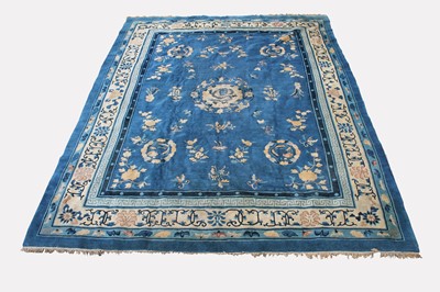 Lot 476 - A Chinese Peking carpet, the indigo field with...