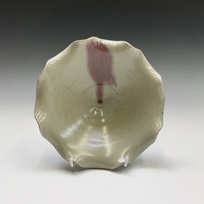 Lot 323 - A footed pottery celadon glazed bowl, with...