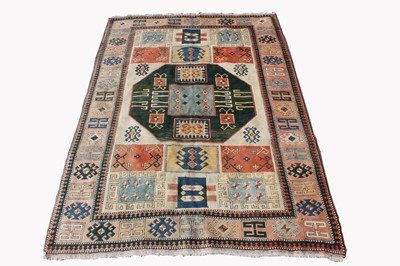 Lot 466 - A Turkish carpet, the ivory field with a...