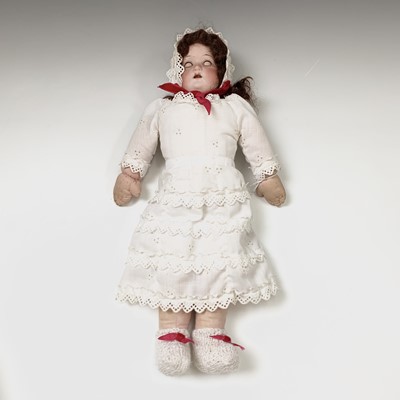 Lot 599 - Doll, bisque head with cloth body, blue glass...