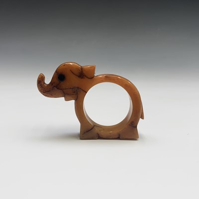 Lot 402 - An amber napkin ring in the form of an...