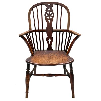 Lot 96 - An ash and elm wheelback windsor armchair, 19th century.