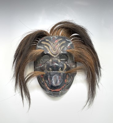 Lot 88 - A Japanese carved wooden painted mask, Meiji...