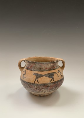 Lot 91 - A Chinese Neolithic earthenware pot, with twin...