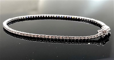 Lot 2545 - An 18ct white gold diamond line bracelet.