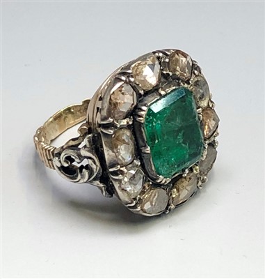 Lot 2561 - An emerald and diamond cluster ring with mine...