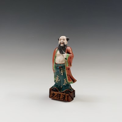 Lot 173 - A Chinese porcelain figure of an immortal,...