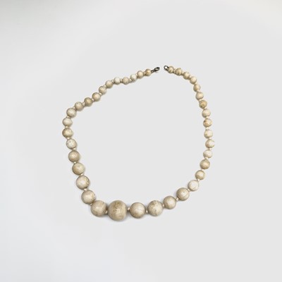 Lot 293 - A graduated knotted ivory bead necklace, clasp...