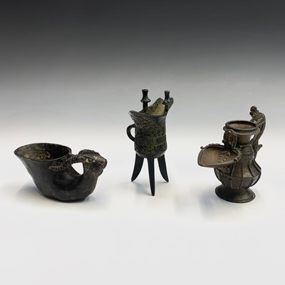 Lot 314 - A Chinese bronze jug, the handle in the form...