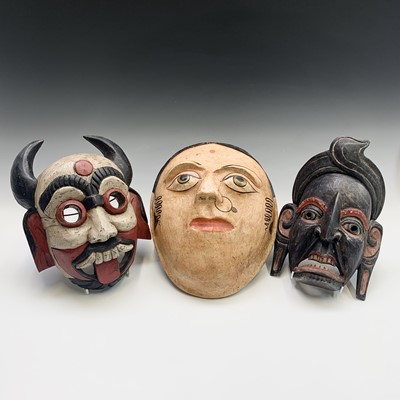 Lot 315 - A Thai carved wood mask, a Balinese wood mask...