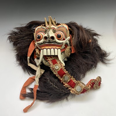 Lot 321 - An Asian painted carved wood mask, with hair,...