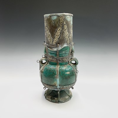 Lot 429 - A Middle Eastern green lustre pottery vase,...