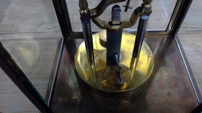 Lot 2936 - A German 400 day brass four glass torsion...