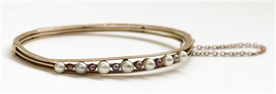 Lot 2781 - A high purity Edwardian gold bangle with a row...