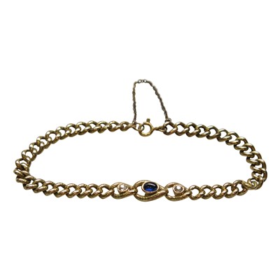 Lot 2785 - A curb link gold bracelet set with a cabouchon...