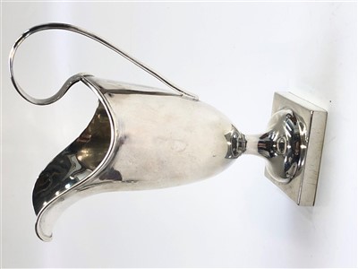 Lot 2053 - A silver helmet cream jug on square foot,...