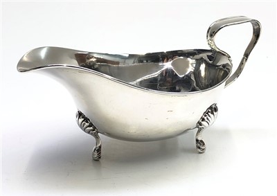 Lot 2057 - A silver sauce boat on three shell capped hoof...