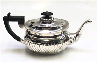 Lot 2058 - A fluted silver teapot by Henry Matthews,...