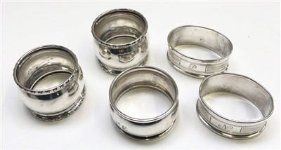 Lot 2115 - Two pairs of silver napkin rings together with...