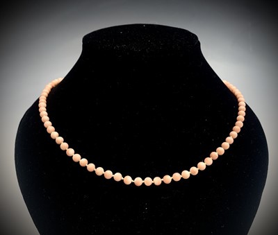 Lot 379 - A pale pink coral bead necklace with 9ct gold...