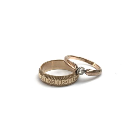Lot 2517 - A 9ct gold ring, solitaire set a diamond and a...