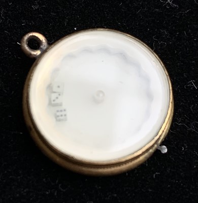 Lot 841 - A gilt gaming fob with a lever that spins a...