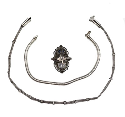 Lot 220 - A Middle Eastern niello enamelled silver two-part buckle and two silver snake chain necklaces.