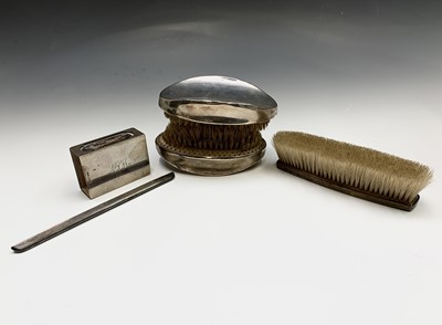 Lot 49 - A pair of heavy silver-mounted brushes one...