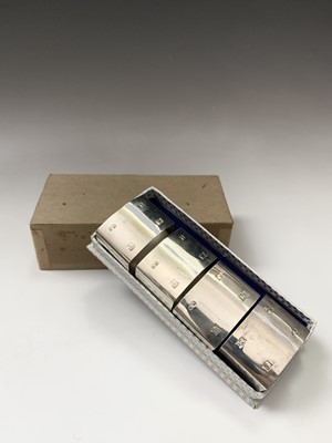 Lot 129 - A set of four silver napkin rings with the...