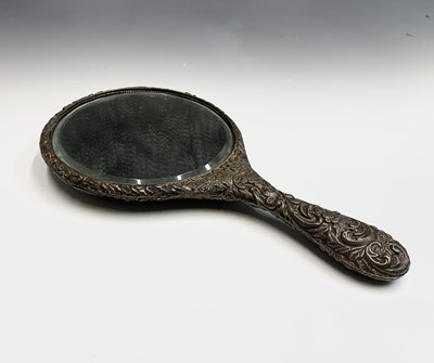 Lot 115 - A silver-mounted hand mirror. Worn