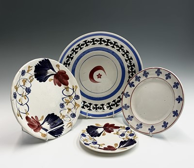 Lot 860 - Three sponged and painted pottery plates and a...