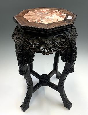Lot 85 - A Chinese carved hardwood jardiniere stand,...