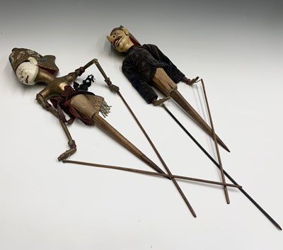 Lot 109 - Two Java painted wood puppets, length 71cm.