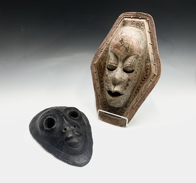 Lot 64 - A painted wall hanging tribal mask, with...