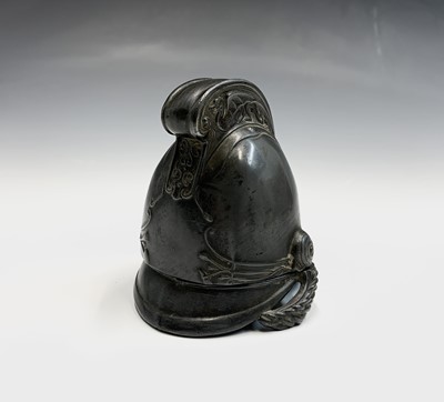 Lot 90 - A pewter inkwell modelled as a fireman's...