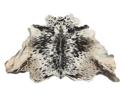 Lot 8 - A cow hide rug, 157.5cm x 154cm.