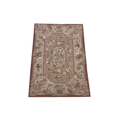 Lot 1216 - A needlepoint woollen rug in Aubusson design,...