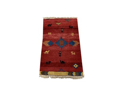 Lot 1211 - A Gabbeh rug, the red field with a central...