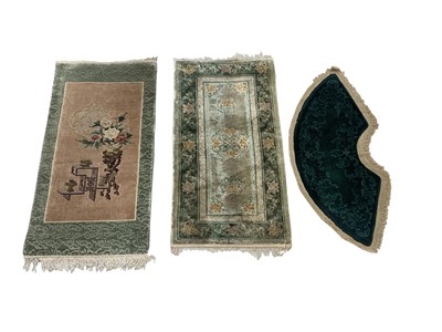 Lot 1205 - Two Chinese silk rugs, 126 x 62cm and 122 x...