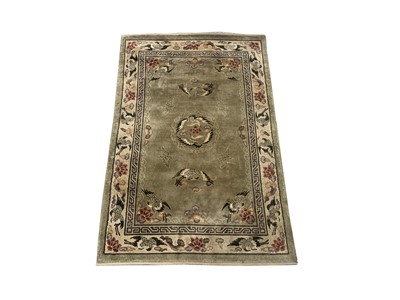 Lot 1206 - A Chinese 'art silk' rug, the green field with...