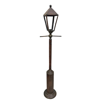 Lot 83 - A tall copper and brass lamp, modelled as a...