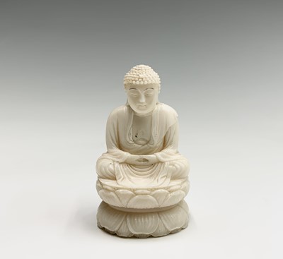 Lot 147 - A Chinese carved ivory figure of a seated...