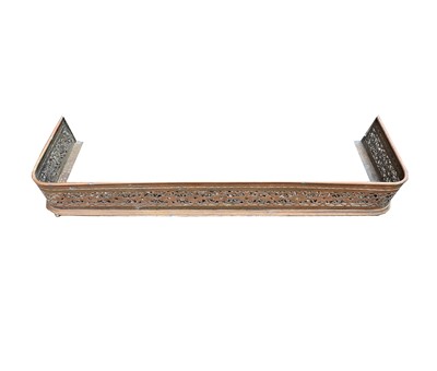 Lot 131 - A 19th century long brass fender, pierced with...