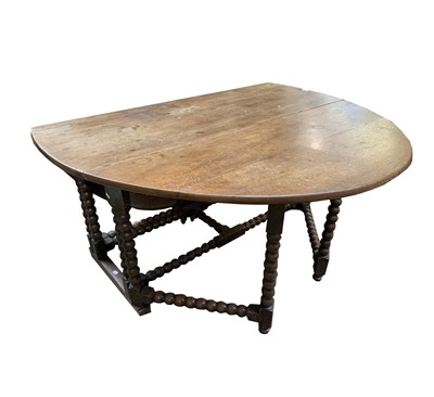 Lot 17 - A large oak oval bobbin turned double gateleg...